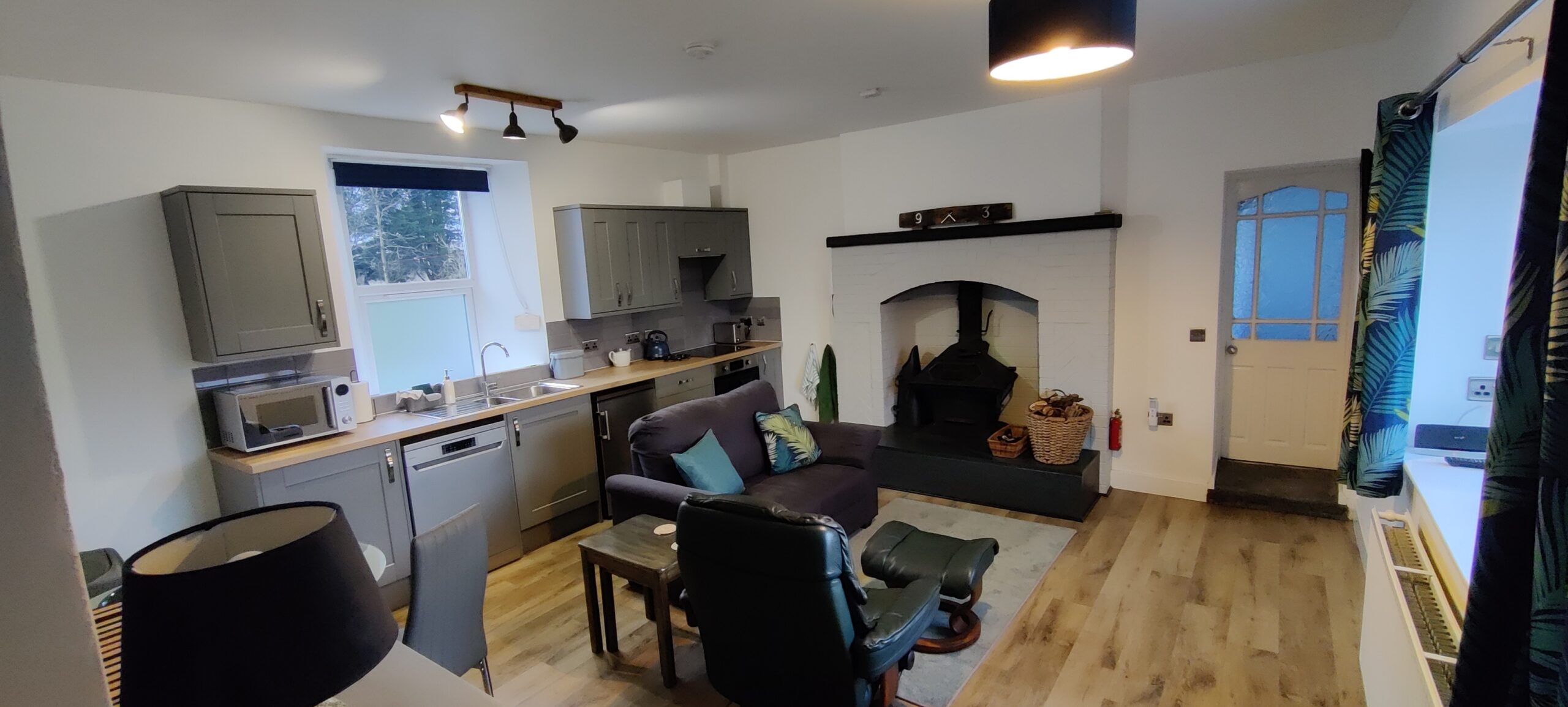 Kitchen Lounge showing kitchen area and log burner.