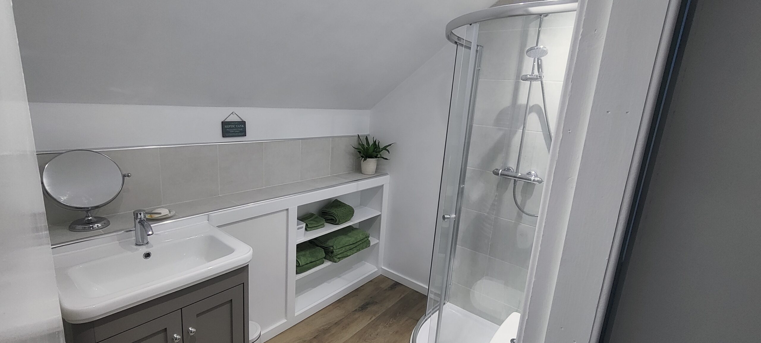 Ensuite Shower room showing shower and wash basin.