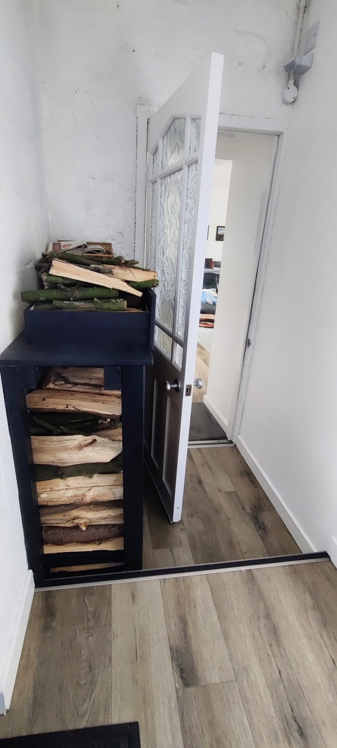 Entrance vestibule showing log store